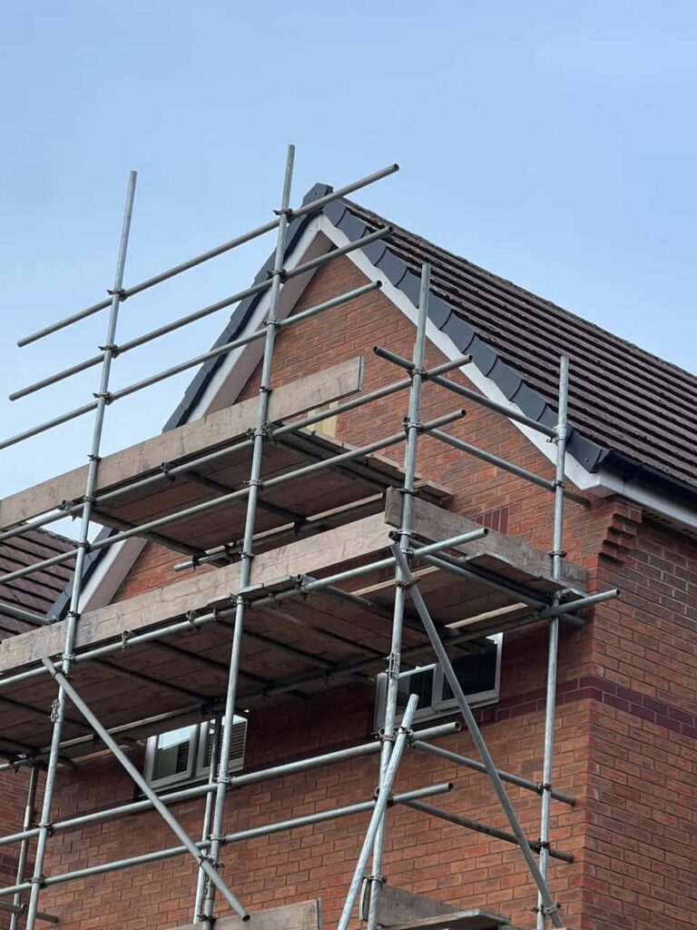 This is a photo of a roof which has just been repaired. There is a scaffold located at the gable end for access onto the roof. Works carried out by LJ Roofing Calne
